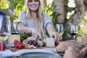 Fromart girl slicing cheese on cheese board