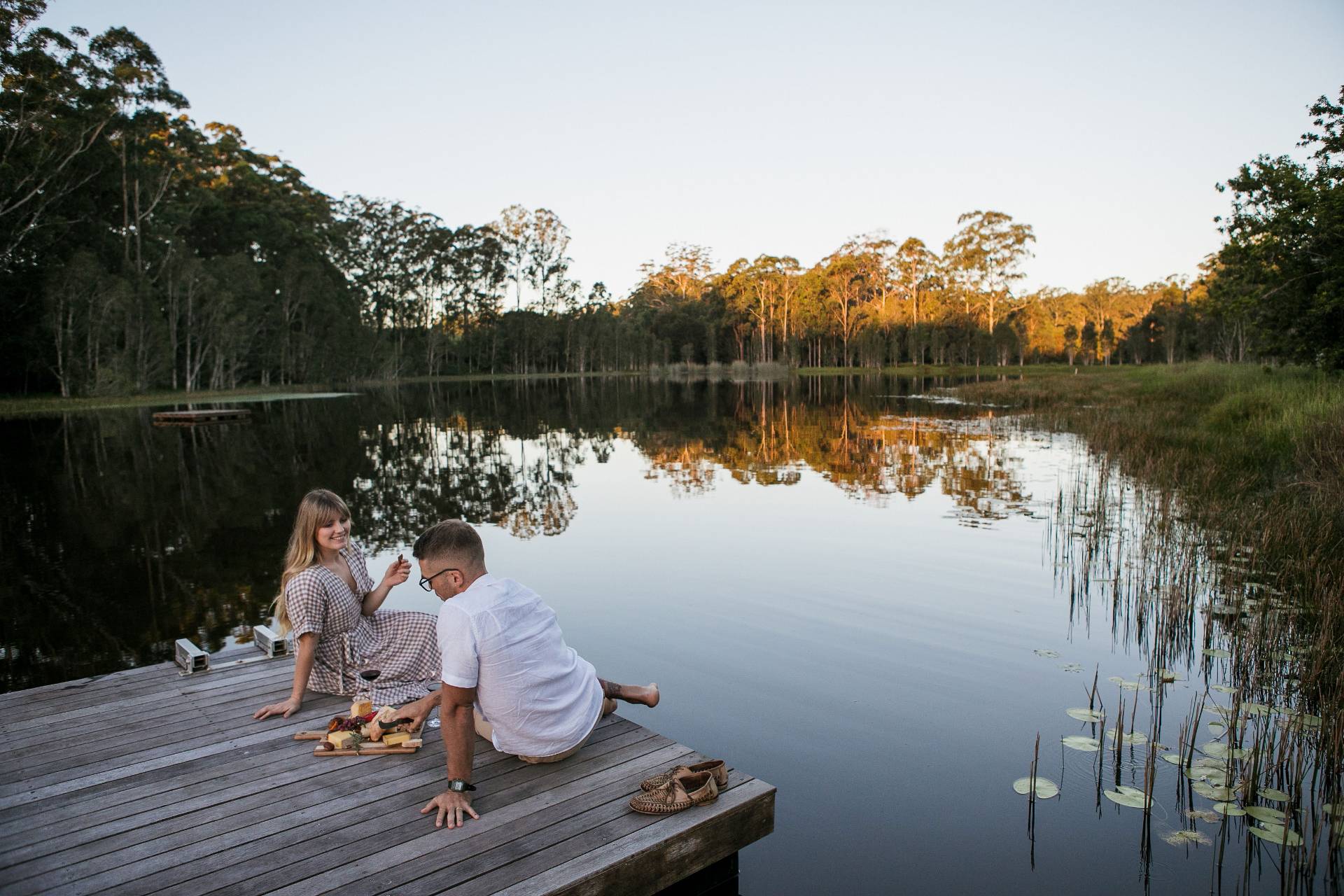 Fromart farm couple eating cheese on lake jetty